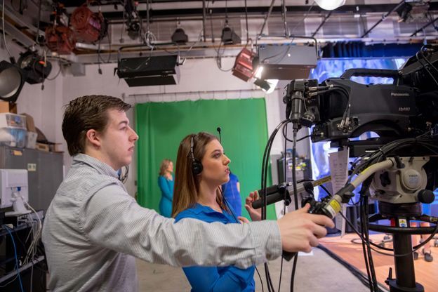 ESPNU Teaching Assistant Ryan Decker helps focus the camera.